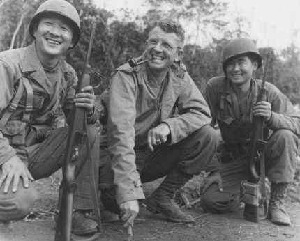 Brig General Frank Merrill poses between two Japanese American interpreters@2x